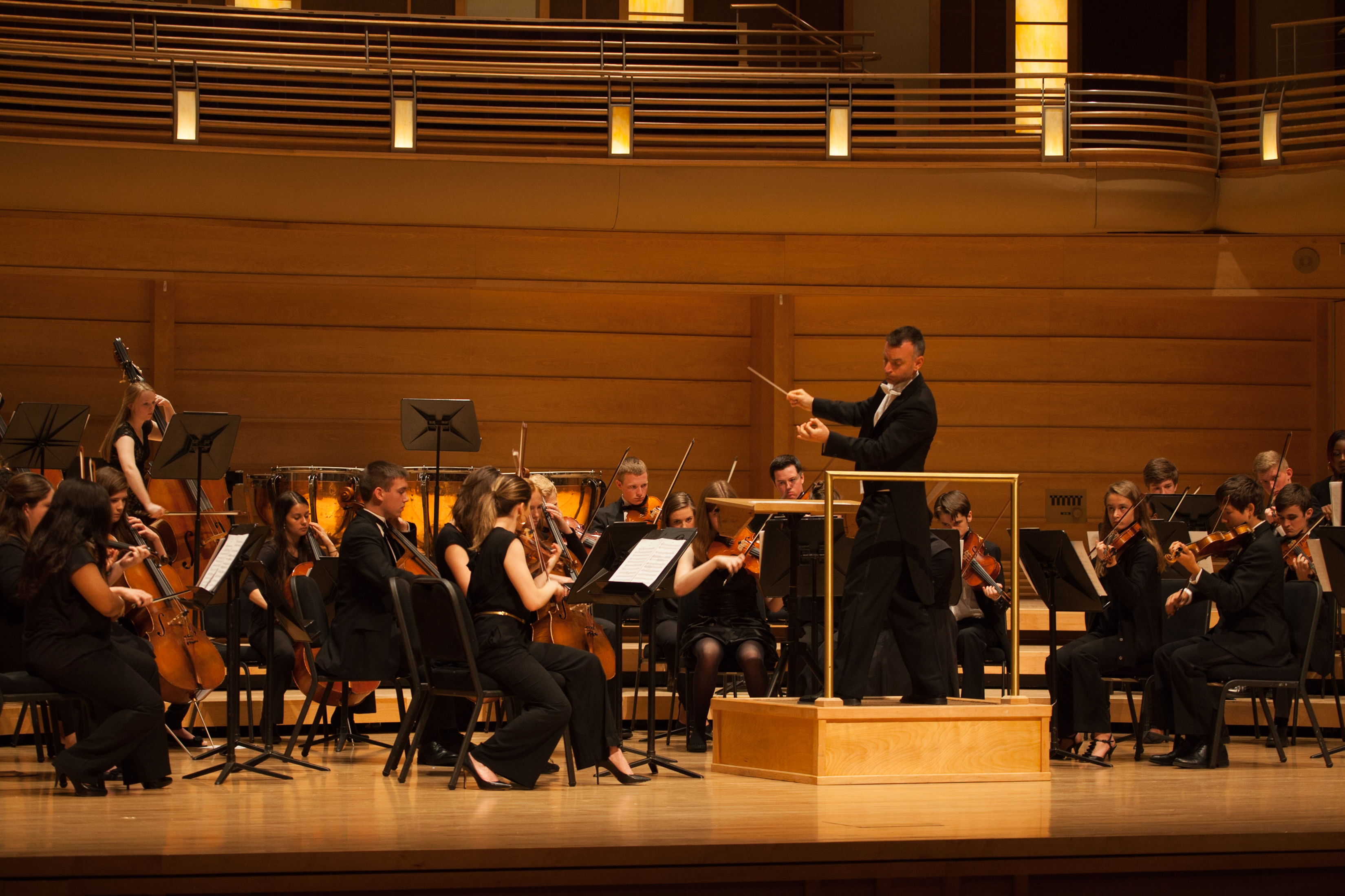 orchestra ensemble performing onstage Festival of Gold